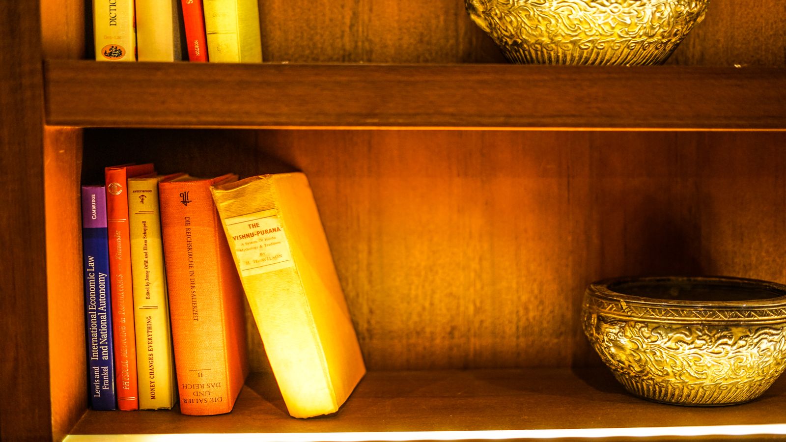 A library shelf with books whose spines shift into personalized titles, viewed through a reading lens